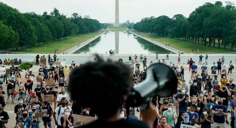 Protesters applaud during a rally against racial inequality in the aftermath of the death in Minneapolis police custody of George Floyd, at the Lincoln Memorial in Washington.  REUTERS/Erin Scott