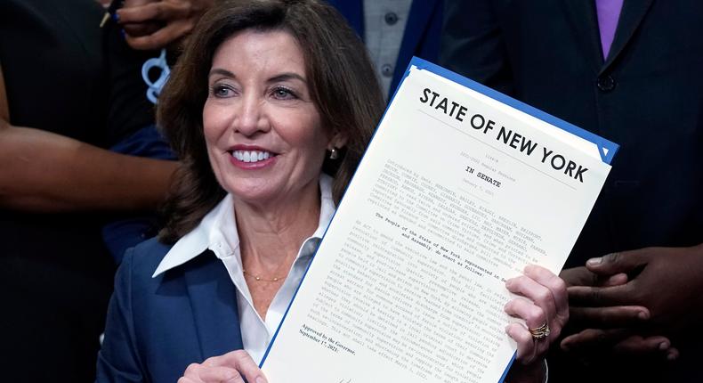 New York Gov. Kathy Hochul holds the Less is More law she signed, during ceremonies in the her office, in New York, Friday, Sept. 17, 2021. New Yorkers will be able to avoid jail time for most nonviolent parole violations under a new law that will take effect in March, and largely eliminates New York's practice of incarcerating people for technical parole violations.
