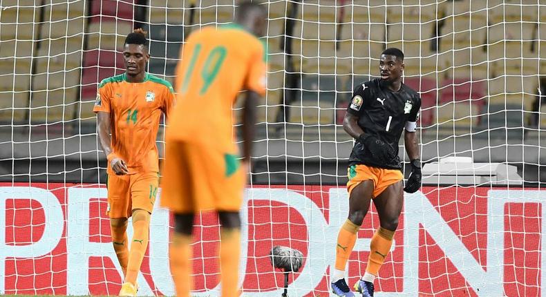 Ivory Coast captain Serge Aurier (R) finished the game in goal after Badra Ali Sangare hurt himself while conceding a bizarre equaliser Creator: CHARLY TRIBALLEAU