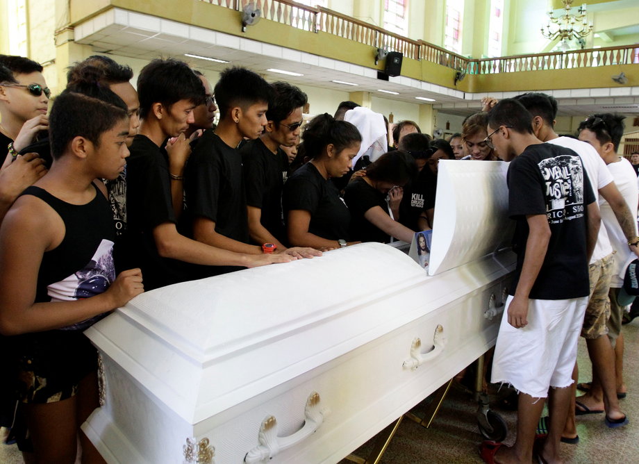 Relatives and friends look at the coffin of Eric Quintinita Sison, a young man killed by police looking for drug dealers, during burial rites in Pasay city, Manila, Philippines, August 31, 2016.