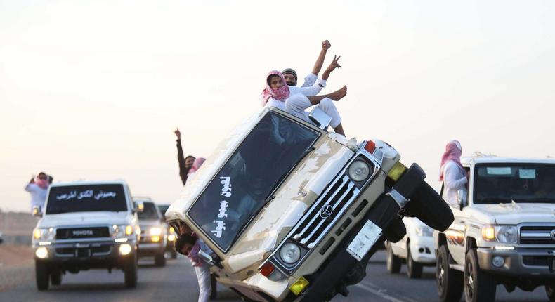 Saudi youths demonstrating a stunt known as sidewall skiing in the northern city of Tabuk, in Saudi Arabia, in 2014.
