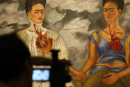 Cameraman films Frida Kahlos painting at Mexico City's Bellas Artes museum