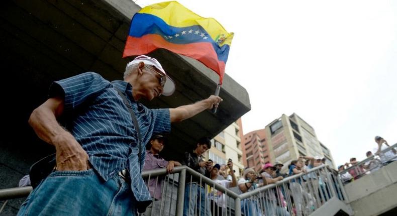 Opposition activists protest against the government in Caracas on May 12, 2017