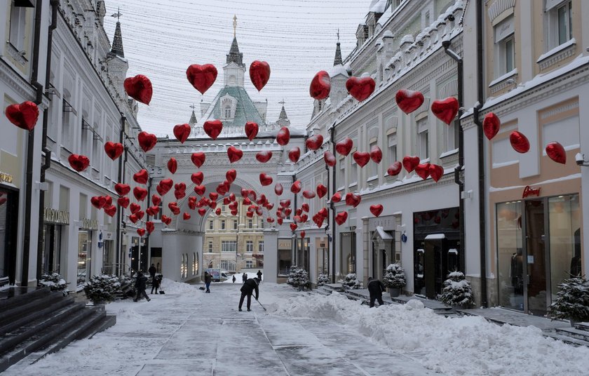 Workers remove snow in a street in Moscow