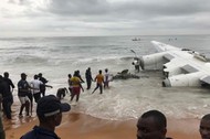 People pull the wreckage of a propeller-engine cargo plane after it crashed in the sea near the international airport in Ivory Coast's main city, Abidjan