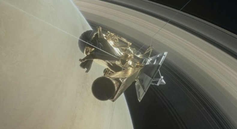 This NASA handout image depicts the Cassini unmanned spacecraft above Saturn's rings