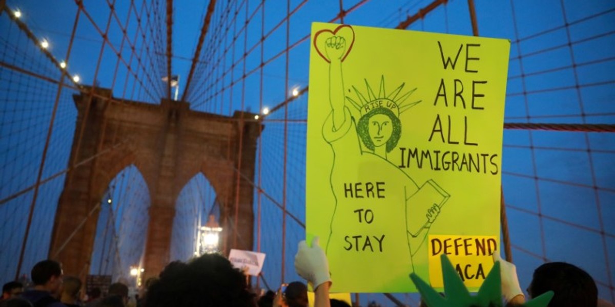 People march across the Brooklyn Bridge to protest the planned dissolution of DACA in Manhattan, New York City, U.S.