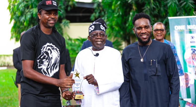 Former Super Eagles' captain Nwankwo Kanu (L) and Austin JJ Okocha presenting All Progressives Congress National Leader, Asiwaju Bola Tinubu, an award when the ex-internationals visited Tinubu in Ikoyi, Lagos on Saturday.