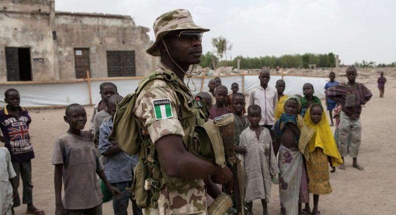 A Nigerian soldier patrols in the town of Banki in northeastern Nigeria on April 26, 2017. Banki has been totally destroyed during battles between the Nigerian army and Boko Haram insurgents. Over 32,000 people live in the town but free movement is limited.