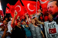 People shout slogans and wave Turkish national flags as they have gathered in solidarity night after