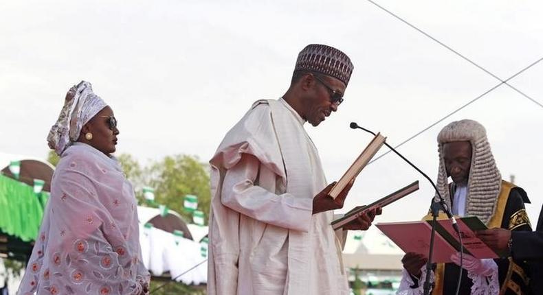 Chief Justice of Nigeria Mahmud Mohammed swears in Muhammadu Buhari (C) as Nigeria's president while Buhari's wife Aisha looks on at Eagle Square in Abuja, Nigeria May 29, 2015. REUTERS/Afolabi Sotunde/File Photo