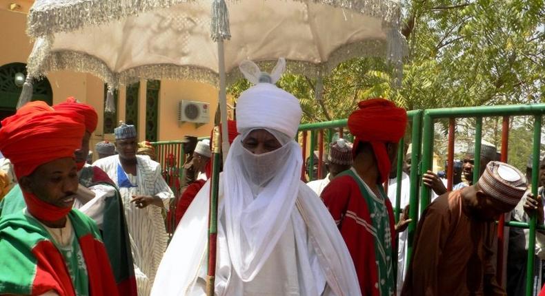 The Emir of Kano Muhammadu Sanusi II (centre) faces allegations of embezzlement, abuse of office and improper conduct