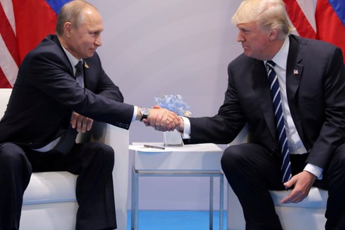 FILE PHOTO - U.S. President Donald Trump shakes hands with Russia's President Vladimir Putin during 