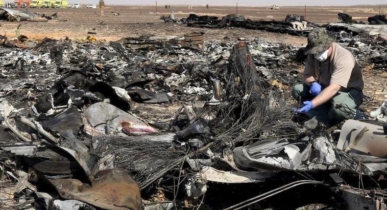 A military investigator from Russia stands near the debris of a Russian airliner at its crash site at the Hassana area in Arish city, north Egypt, in this November 1, 2015 file photo. 