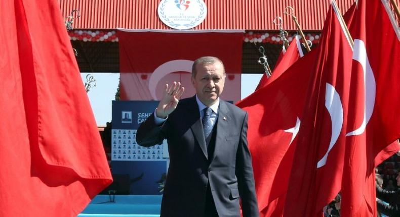 Turkish President Recep Tayyip Erdogan waves as he arrives to attend a ceremony marking the 102nd anniversary of the Canakkale Victory