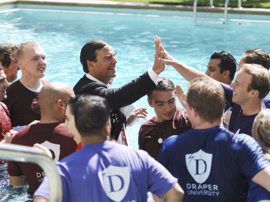 Tim Draper surrounded by students in the "Startup U" reality TV show.