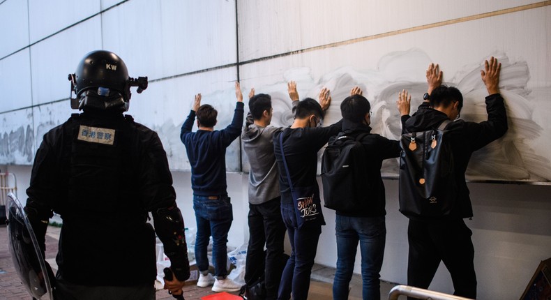 People are detained by the police after a rally in Hong Kong on December 22, 2019 to show support for the Uighur minority in China.
