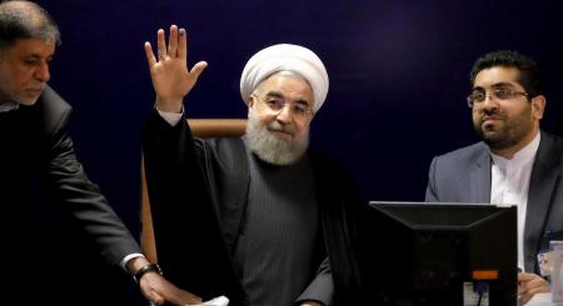 Iranian President Hassan Rouhani (C) waves after he registered for Februarys election of the Assembly of Experts, the clerical body that chooses the supreme leader, at the Interior Ministry in Tehran December 21, 2015.