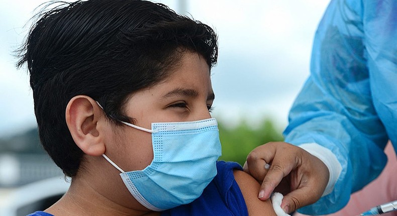 A boy receives the first dose of the Pfizer/BioNTech COVID-19 vaccine in Tegucigalpa, on September 25, 2021, during a vaccination programme for teens aged 12 to 15
