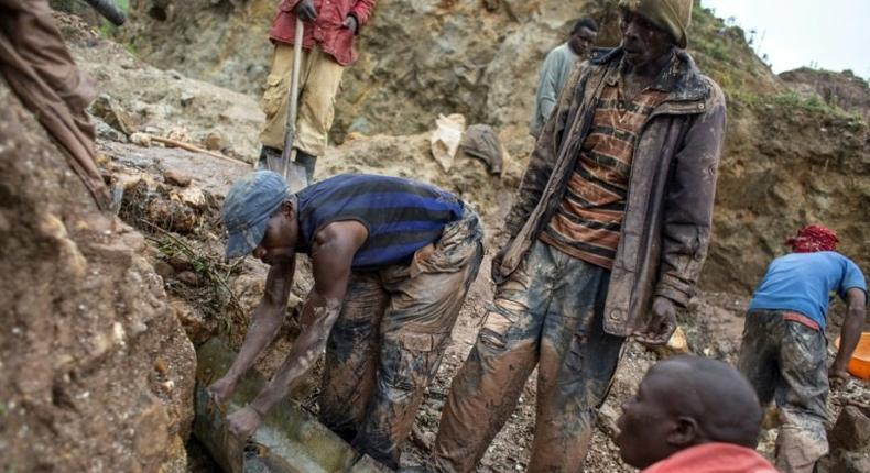 Sorting and washing rocks at a cassiterite mining site near Numbi in eastern Democratic Republic of Congo.