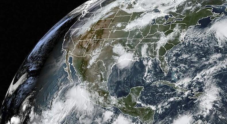 This satellite image obtained from NOAA/RAMMB, shows Hurricane Lorena (L) on September 19, 2019 as it made landfall on the southwest coast of Mexico