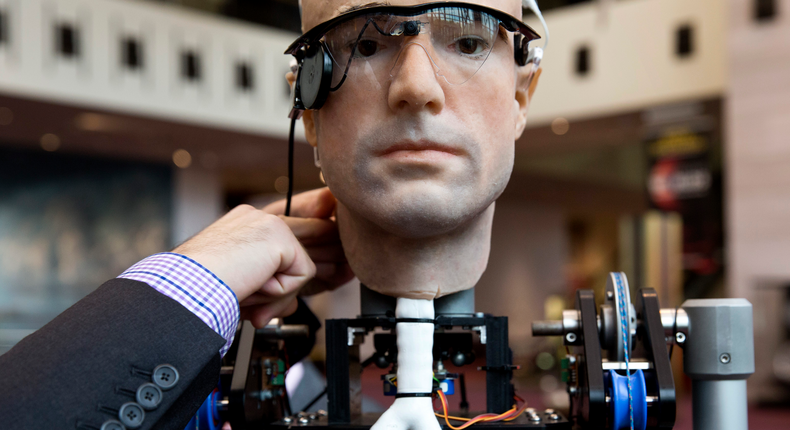 An engineer makes an adjustment to the robot The Incredible Bionic Man at the Smithsonian National Air and Space Museum in Washington October 17, 2013.