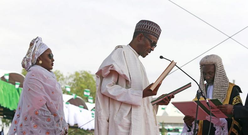 Chief Justice of Nigeria Mahmud Mohammed swears in Muhammadu Buhari (C) as Nigeria's president while Buhari's wife Aisha looks on at Eagle Square in Abuja, Nigeria May 29, 2015. REUTERS/Afolabi Sotunde