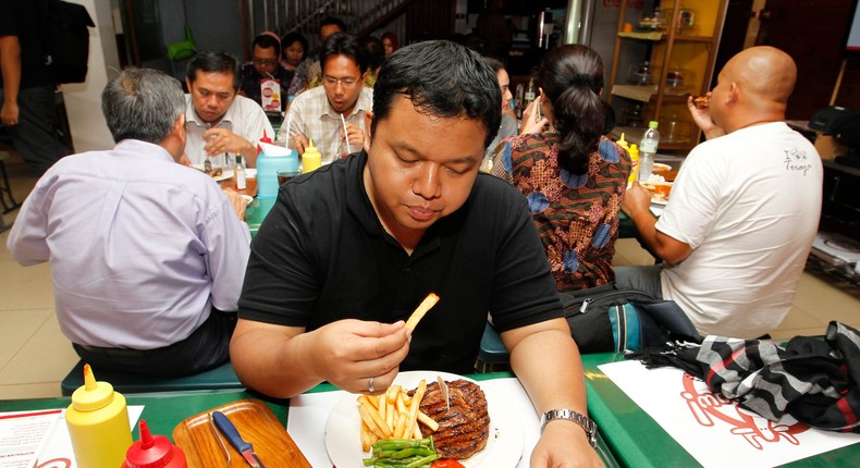 A man eats his lunch at Holycow steak house in Jakarta, Indonesia on December 7, 2012.
