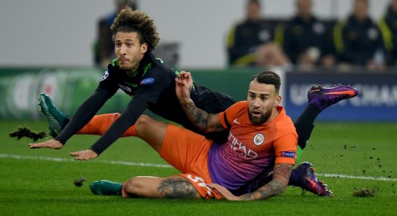 Moenchengladbach's defender Fabian Johnson and Manchester City's defender Nicolas Otamendi fight for the ball