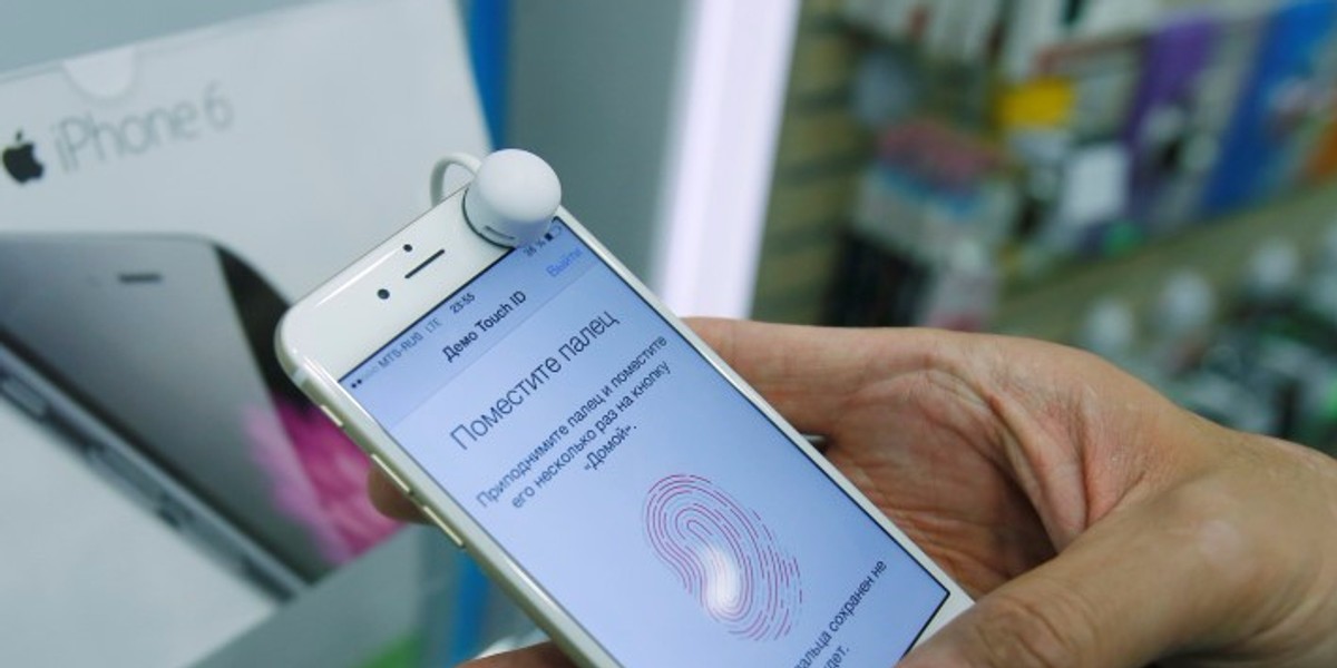 A man holds an iPhone 6 in a mobile phone shop in Moscow