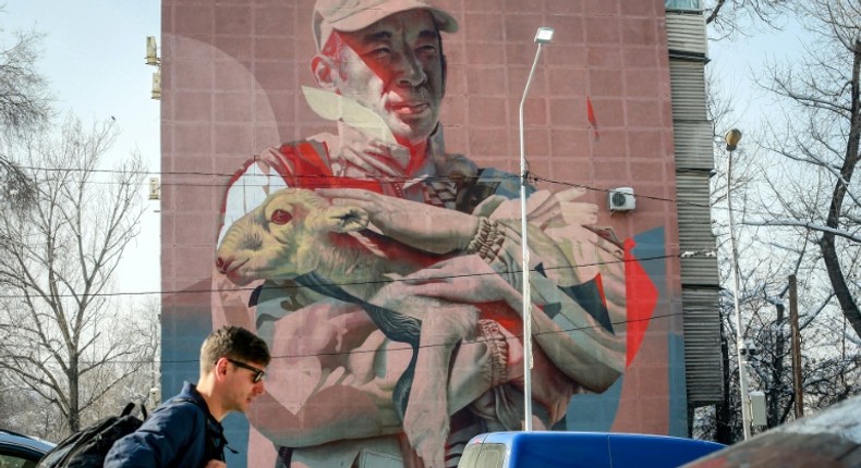 A mural in Almaty depicts Yerlan Nurgaliyev cradling a baby saiga antelope