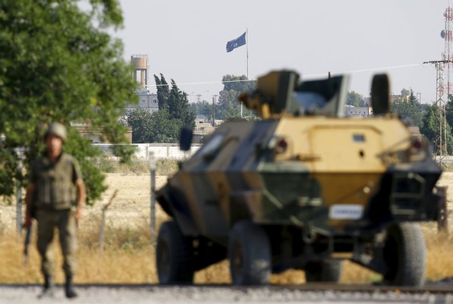 An Islamic State flag flies in the northern Syrian town of Tel Abyad as it is pictured from the Turkish border town of Akcakale, in Sanliurfa province, Turkey.