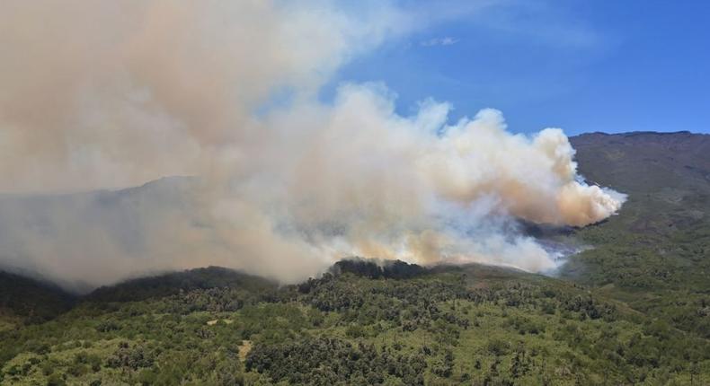 Seen from a helicopter, smoke ascends from the moorlands at Kenya's highest mountain on March 1, 2019, during a fierce forest fire raging on Mount Kenya's national park for nearly a week as wildlife rangers, soldiers and teams of volunteers fight to stem the fire. (Photo by TONY KARUMBA/AFP via Getty Images)