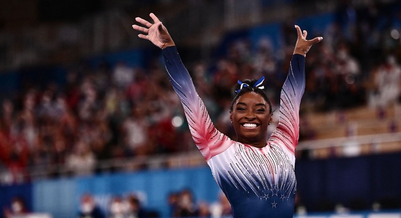 Simone Biles smiles after her balance beam routine at the Tokyo Olympics.JEFF PACHOUD/AFP via Getty Images