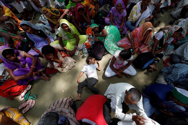 A boy sleeps as farmers attend a protest against the killing of six farmers during last week's clash