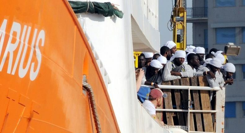 Migrants and refugees arrive at the Trapani port on the Aquarius vessel on July 22, 2016 after being rescued at sea 