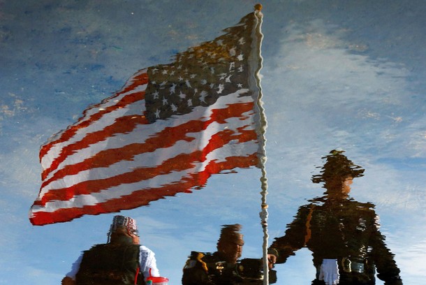 Law enforcement officers seen in a reflection gather in front of the Living Faith Christian Center b