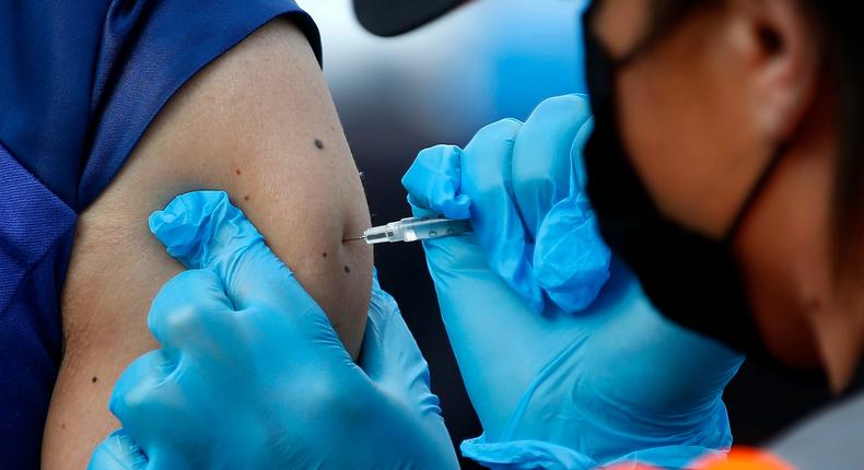 A person is injected with a COVID-19 vaccine at the Oakland Coliseum in Oakland, California, March 11, 2021.
