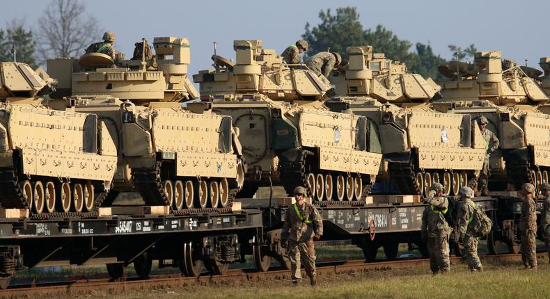 Members of the US Army 1st Division 9th Regiment 1st Battalion unload heavy combat equipment including Abrams tanks and Bradley fighting vehicles at the railway station near the Pabrade military base in Lithuania, on October 21, 2019.
