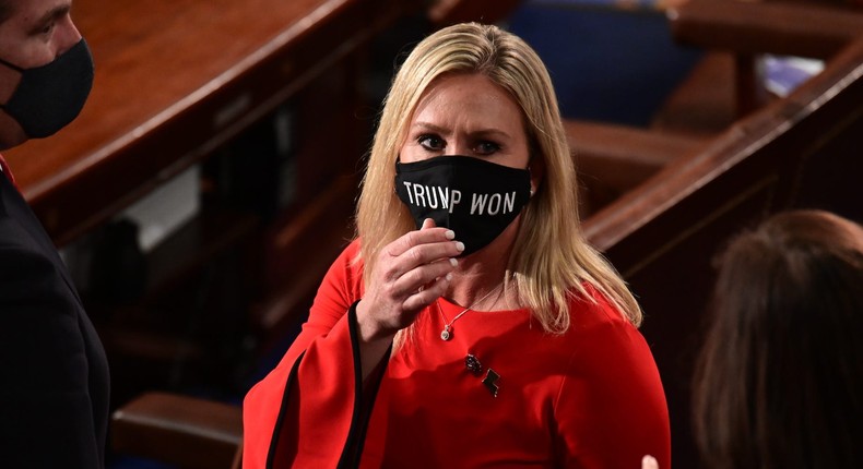 Rep. Marjorie Taylor Greene seen here on the floor of the US House wearing a mask that incorrectly states Trump won.