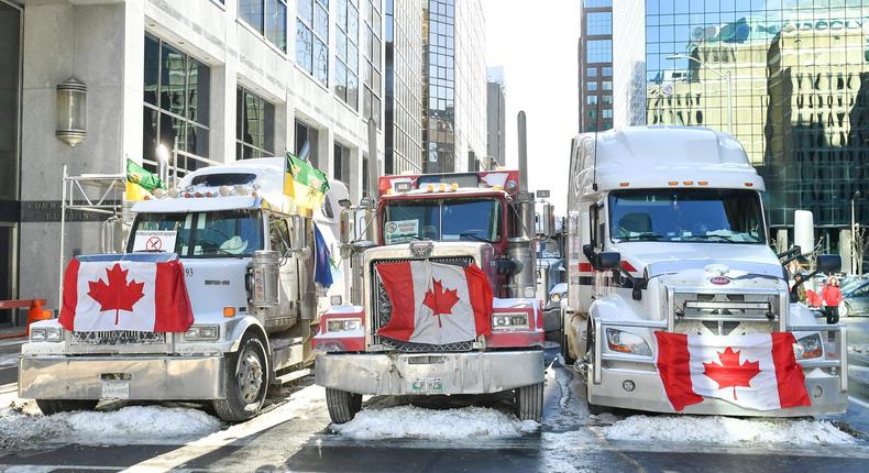 Truckers lineup their trucks on Metcalfe Street as they honk their horns on February 5, 2022 in Ottawa, Canada.
