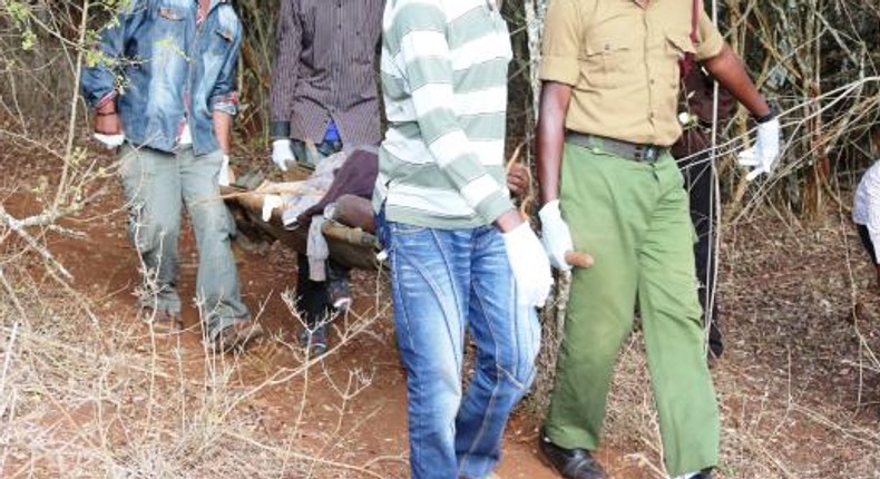 Officers carry away an unidentified body