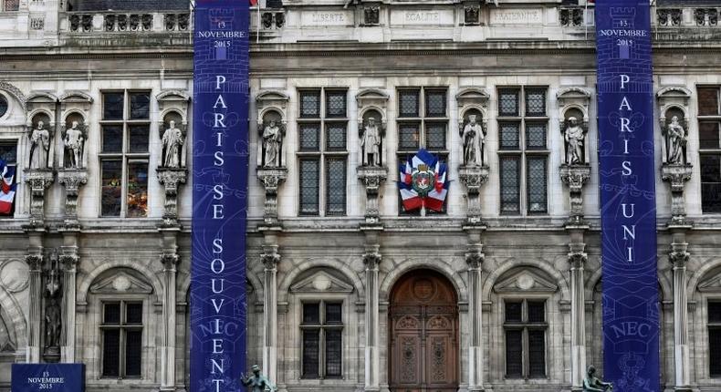 Banners reading Paris remembers and Paris United in memory of the victims of last year's November 13 jihadist attacks in and around Paris on the facade of Paris' City Hall