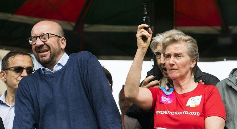 Prime Minister Charles Michel reacts as Princess Astrid of Belgium fires the starting pistol for a running race in Brussels on May 28