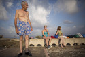 Retired computer programmer Esperanza Delgado smokes a cigarette before swimming in Havana