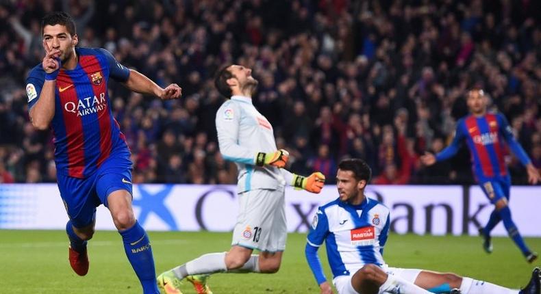 Barcelona's forward Luis Suarez (L) celebrates his goal on December 18, 2016