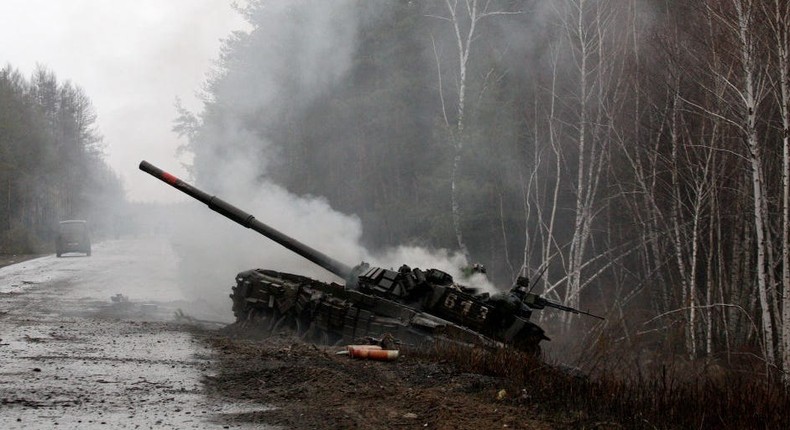 Smoke rises from a Russian tank destroyed by the Ukrainian forces on the side of a road in Luhansk region on February 26, 2022.