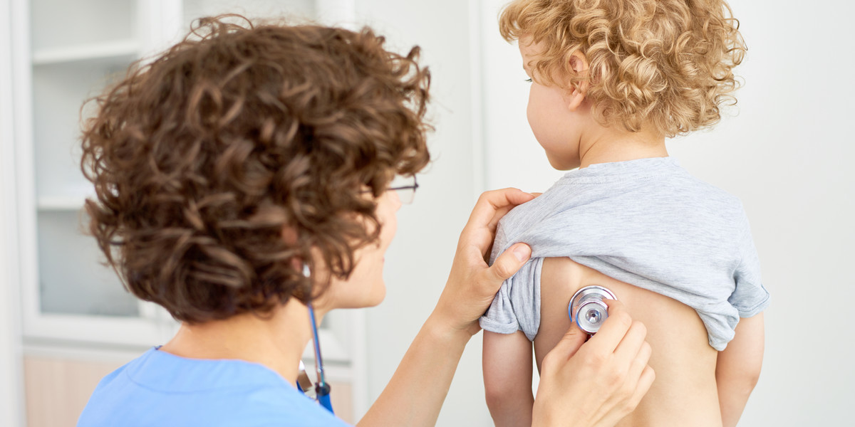 Pediatrician Listening to Boys Breathing