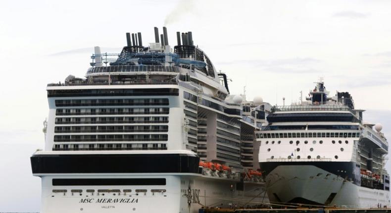 The MSC Merviglia cruise ship (L) lying off Cozumel, Mexico, on February 27, 2020