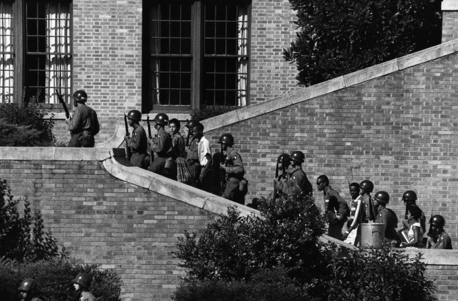 Federal troops escort the "Little Rock Nine" — a group of nine black students who attempted to enter a racially segregated high school — in 1957.